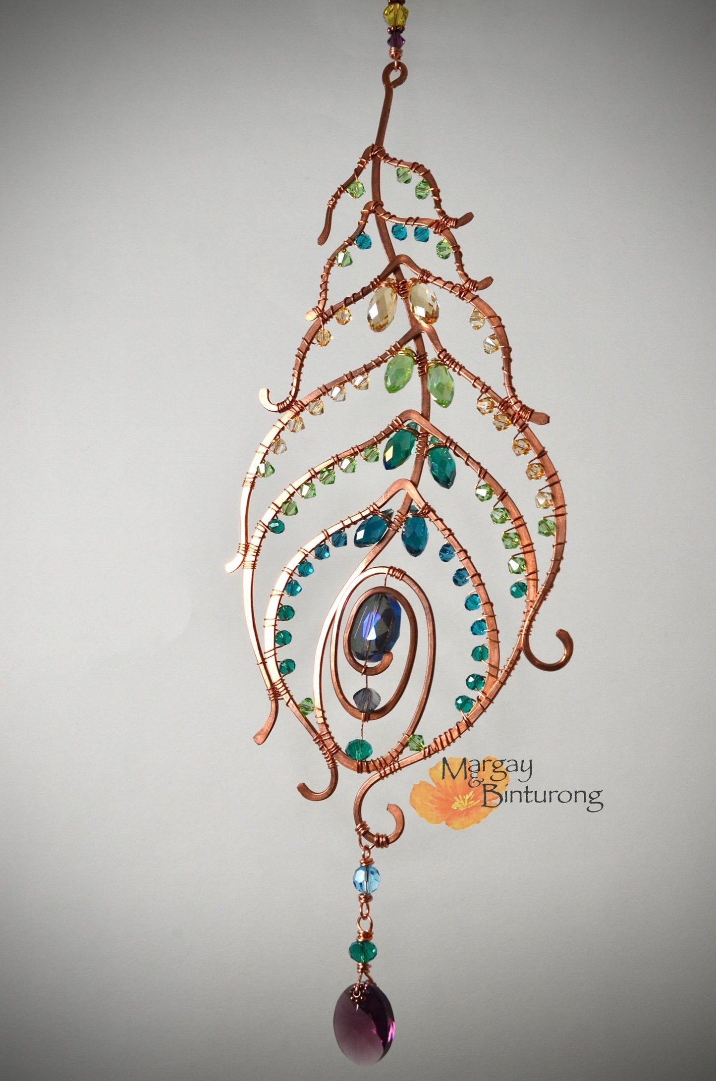 Peacock feather gemstone suncatcher fills the room with sparkles from crystal prism beads