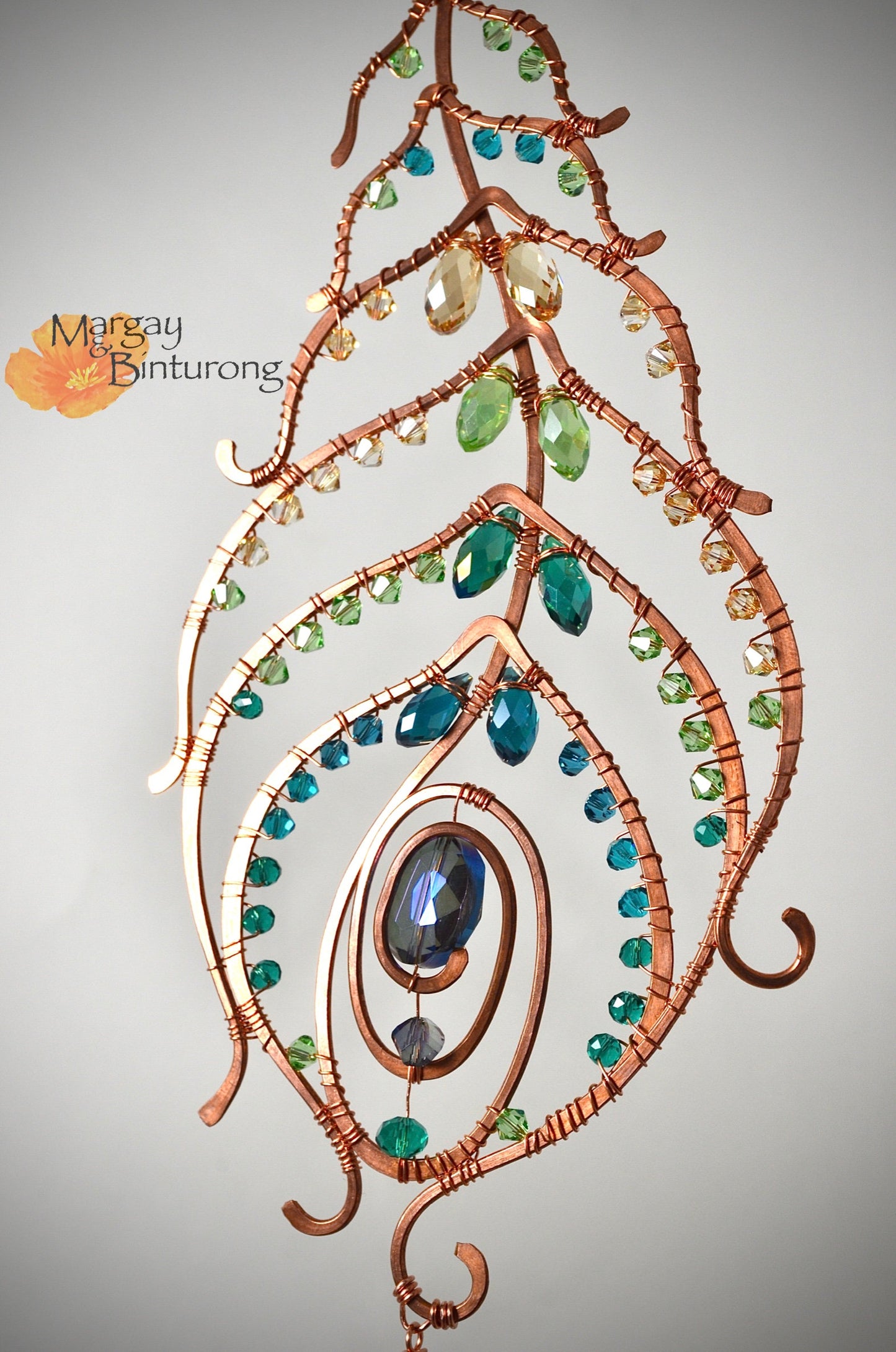 Peacock feather gemstone suncatcher fills the room with sparkles from crystal prism beads