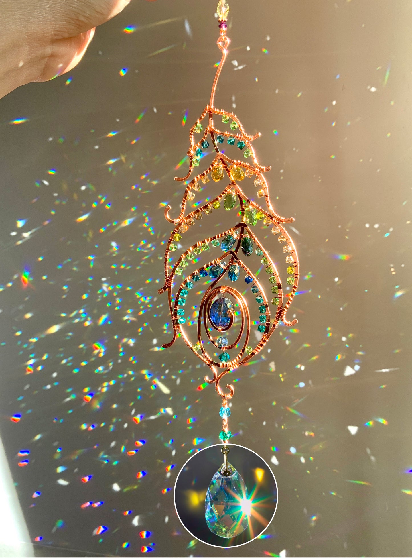 Peacock feather gemstone suncatcher fills the room with sparkles from crystal prism beads