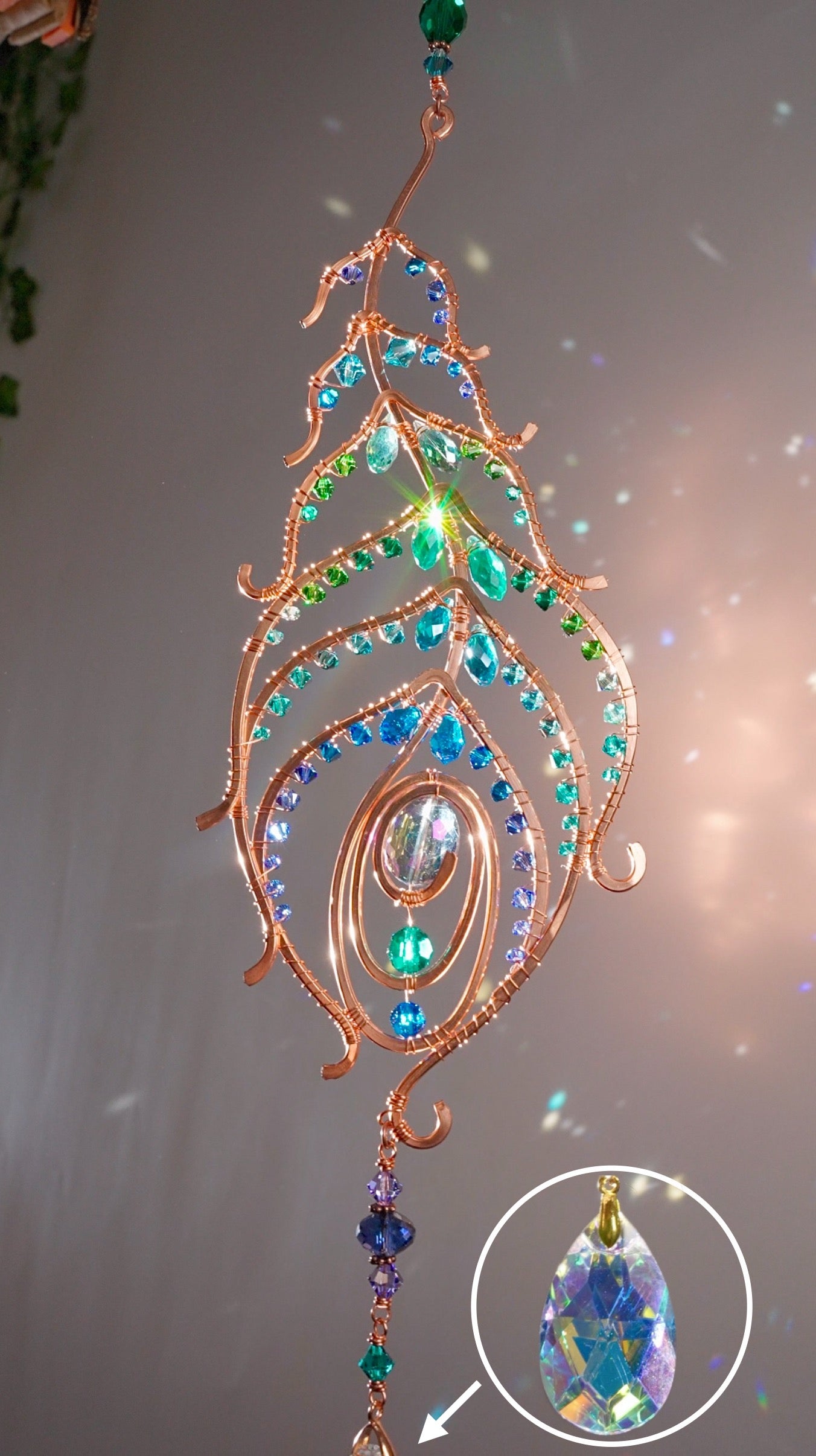 Peacock feather gemstone suncatcher fills the room with sparkles from crystal prism beads