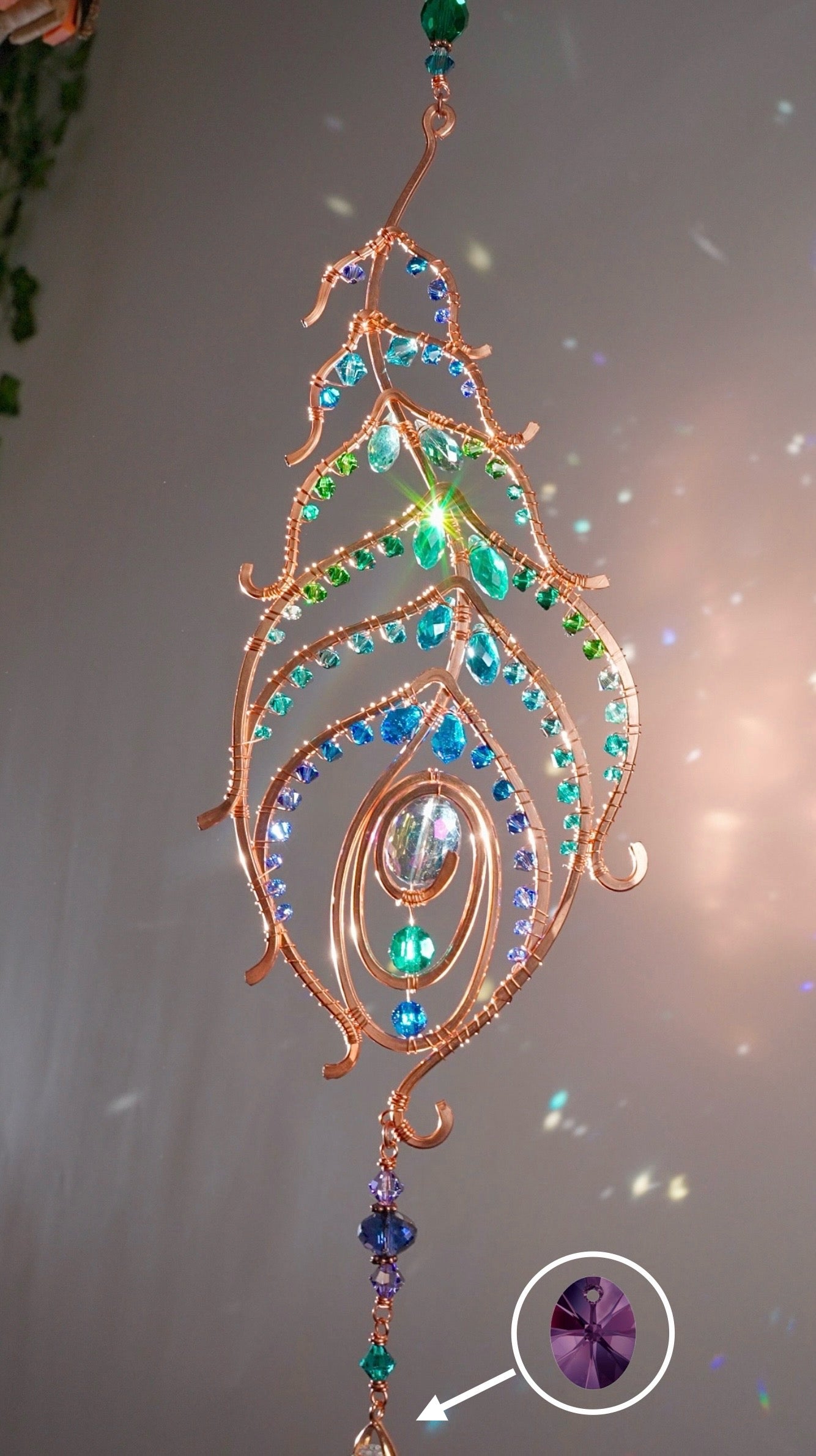 Peacock feather gemstone suncatcher fills the room with sparkles from crystal prism beads