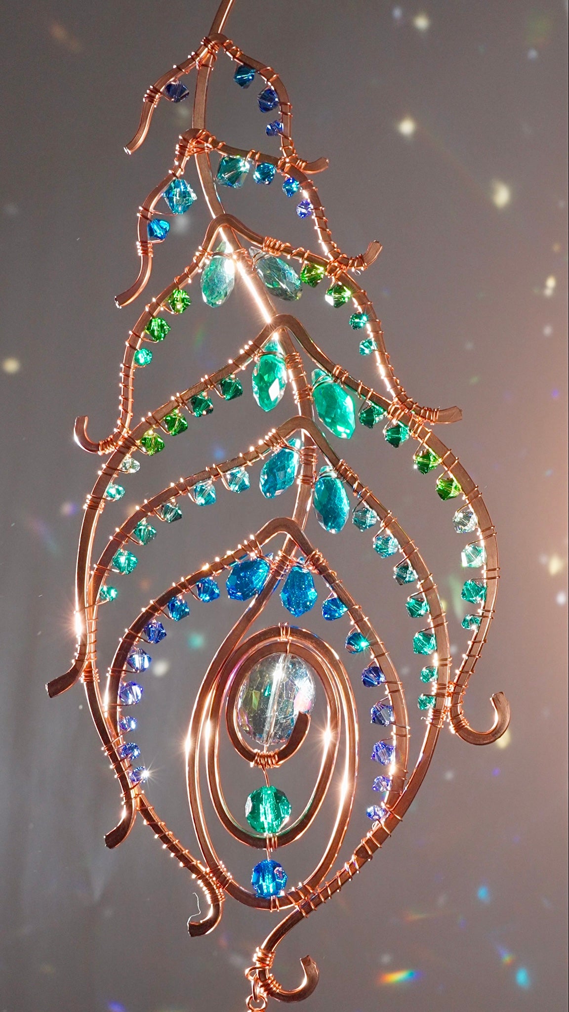 Peacock feather gemstone suncatcher fills the room with sparkles from crystal prism beads