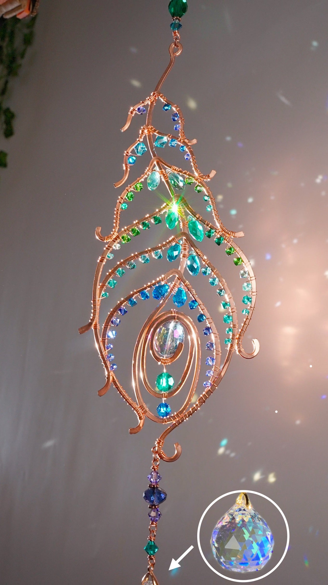 Peacock feather gemstone suncatcher fills the room with sparkles from crystal prism beads