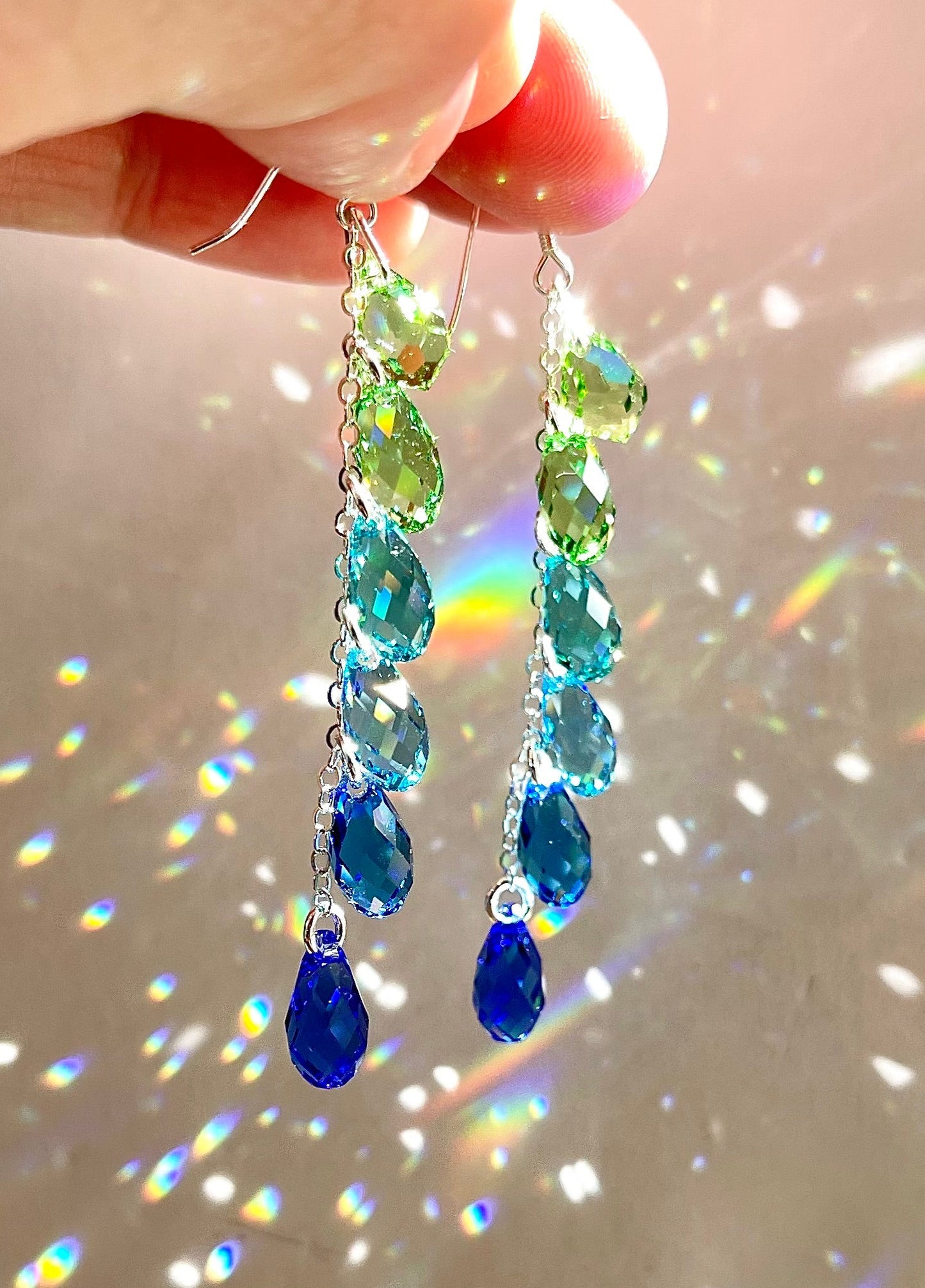 Sparkly Crystal Teardrop Waterfall Earrings with peridot green, aqua, and sapphire blue arranged in an ombré color gradient