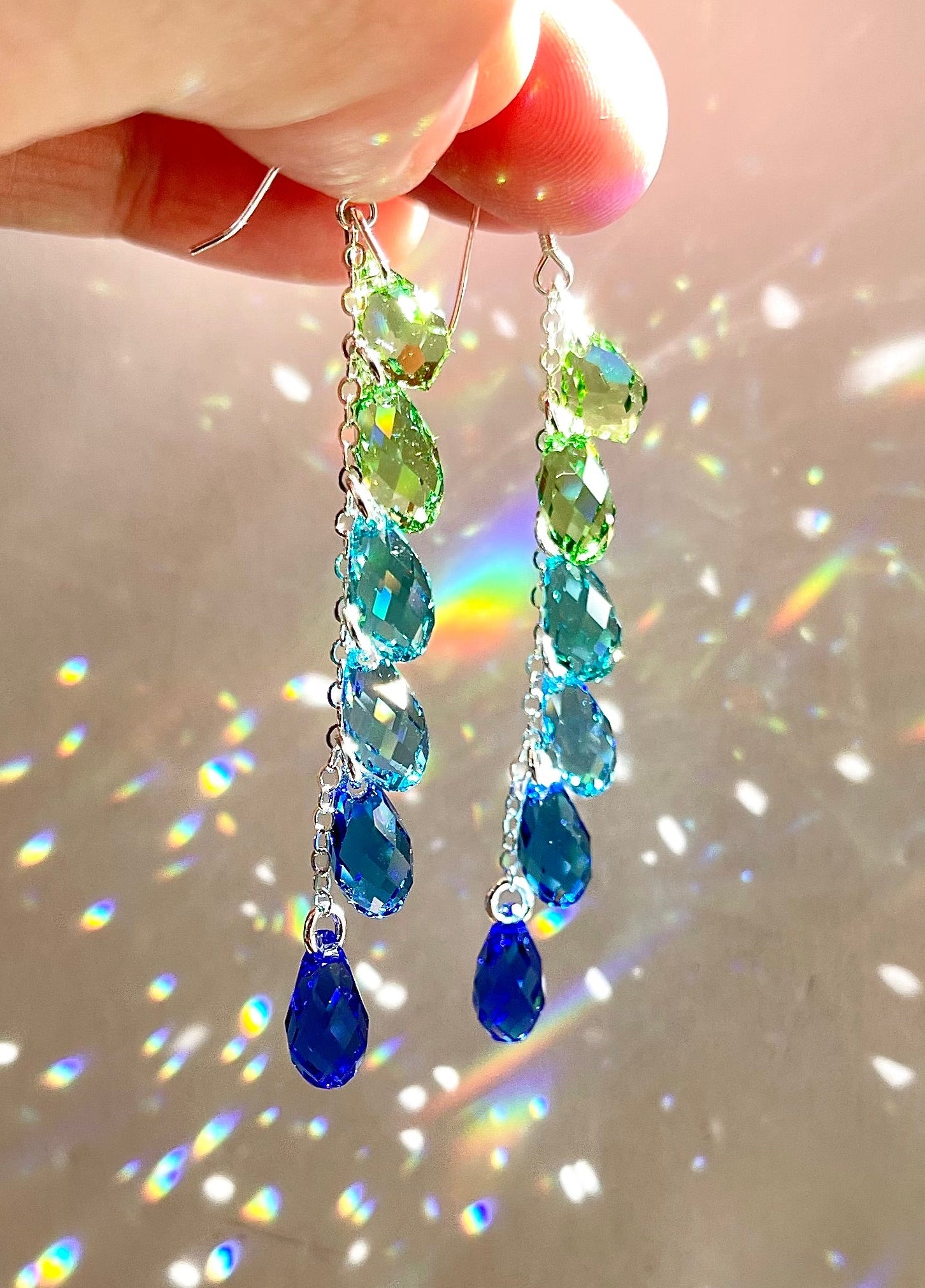 Sparkly Crystal Teardrop Waterfall Earrings with peridot green, aqua, and sapphire blue arranged in an ombré color gradient