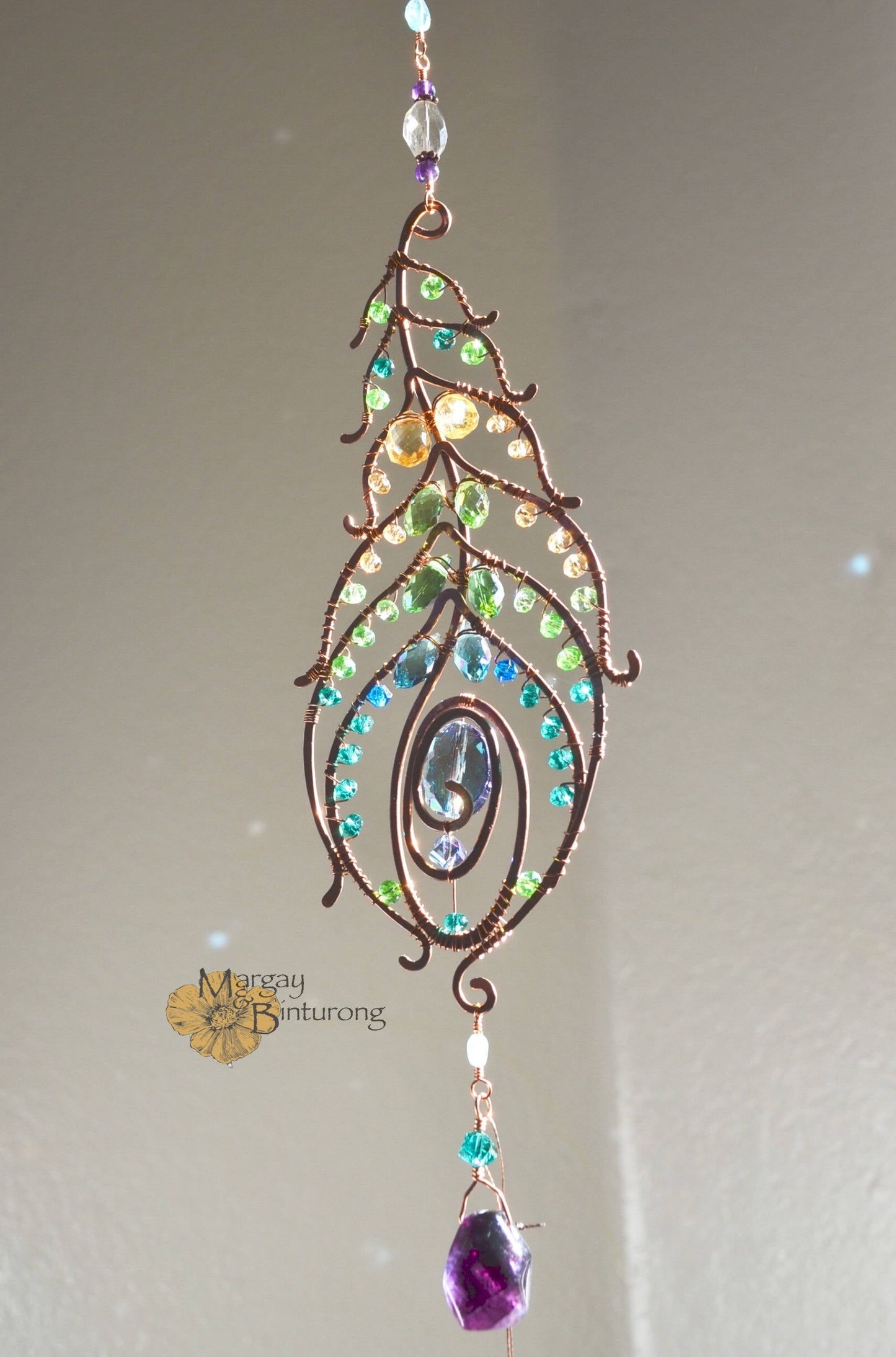 Peacock feather gemstone suncatcher fills the room with sparkles from crystal prism beads